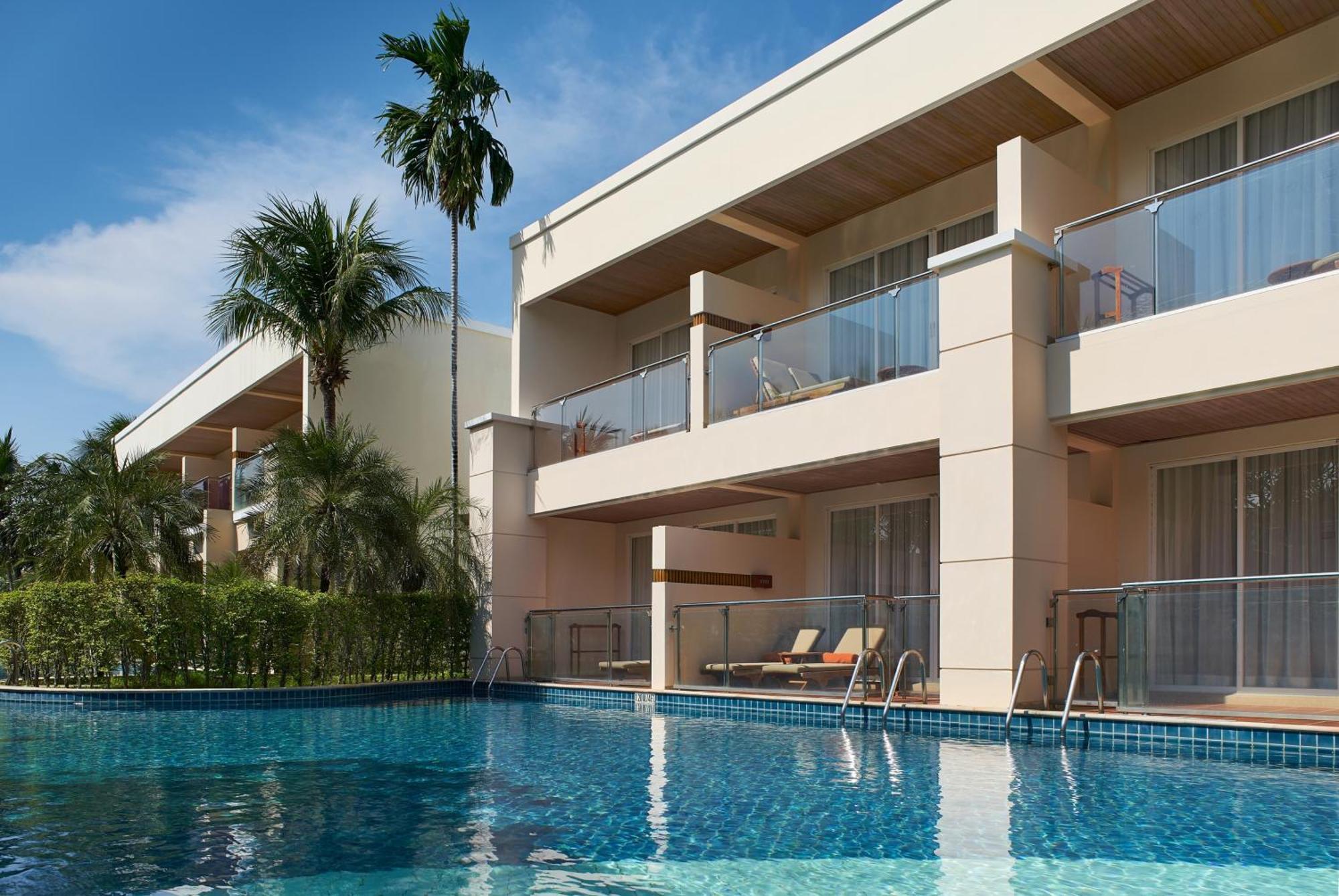 Suite mit 1 Schlafzimmer mit Kingsize-Bett und Blick auf die Lagune und den Pool